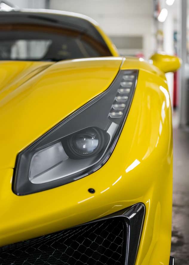 Close up shot of car yellow Ferrari 488 Pista after paintwork protection, paint protection film (PPF) and ceramic coating application.