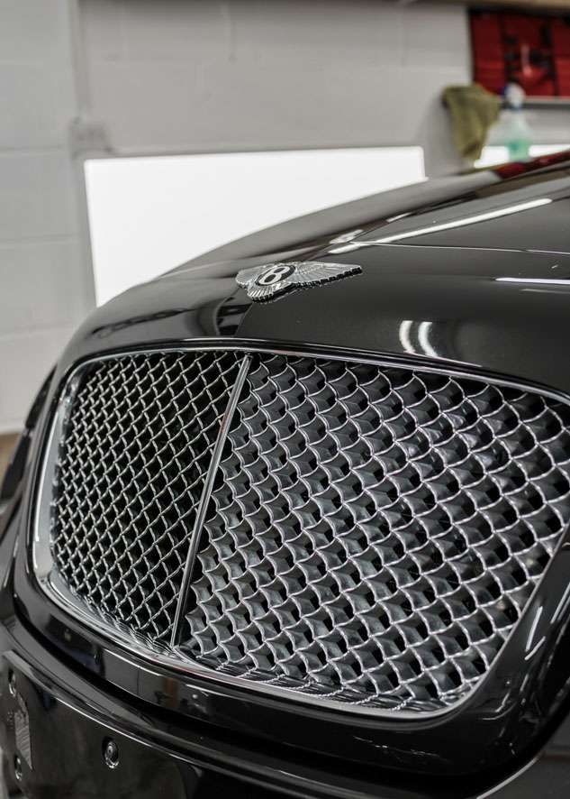 Shiny bonnet of Bentley Flying Spur car after polishing, paint correction and Paintwork Enhancement