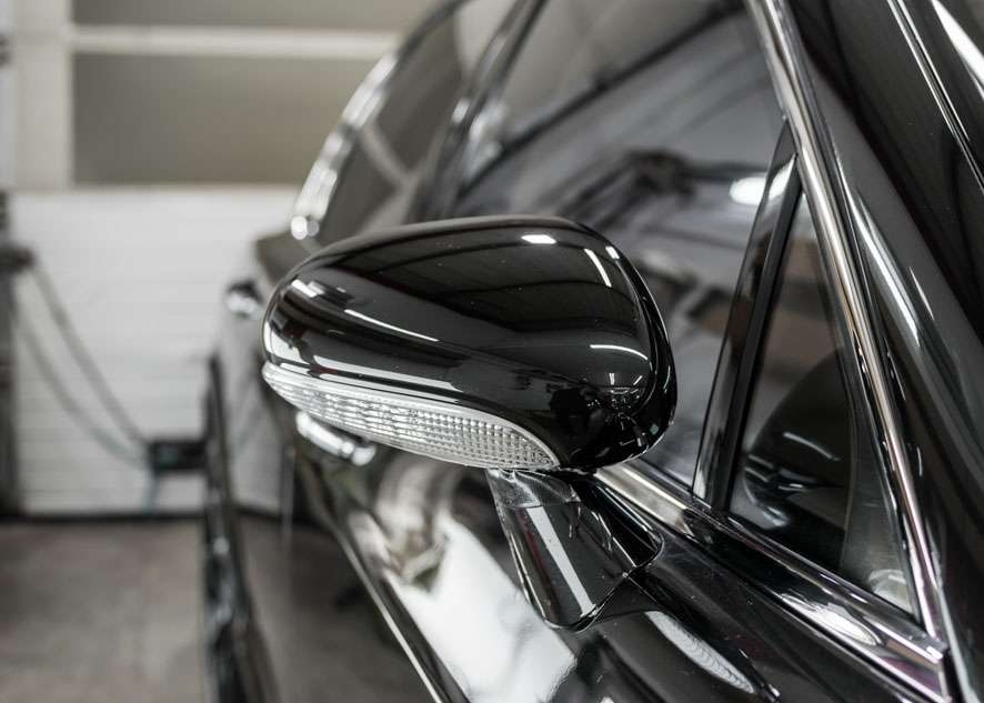 Close up shot of Bentley Flying Spur side mirror with scratches removed by polishing, paint correction and Paintwork Enhancement