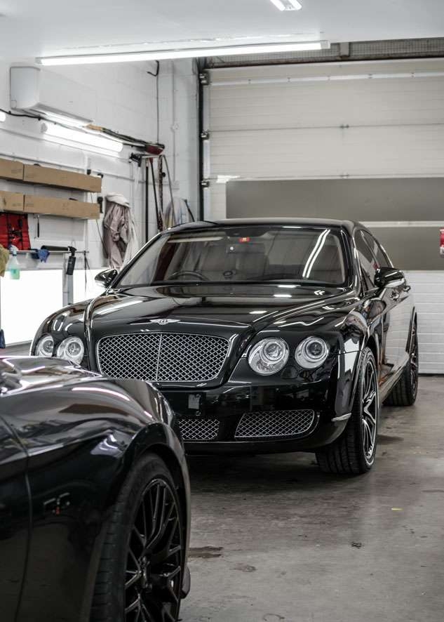 Shiny Bentley Flying Spur car after polishing, paint correction, Paintwork Enhancement and headlight restoration