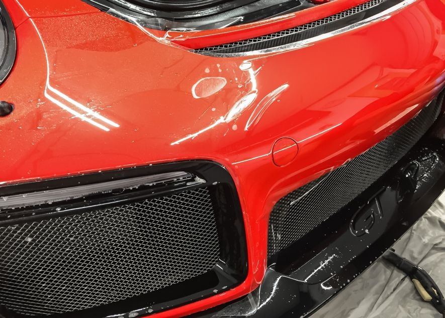 Paint protection film application on Porsche 911 GT2RS red car