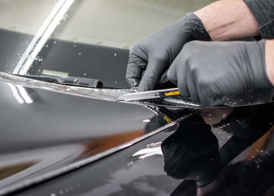 Paint protection film (PPF) being trimmed