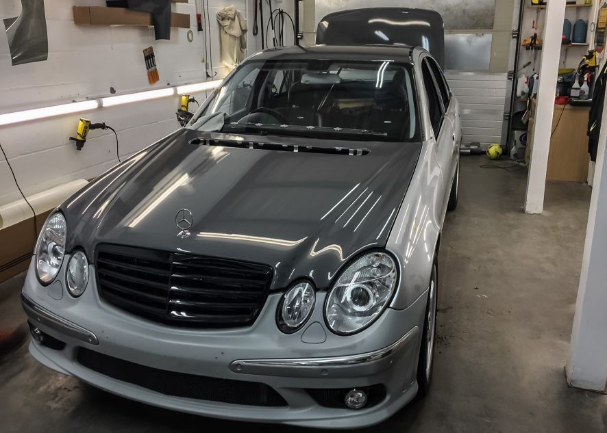 Mercedes E55 AMG being vinyl wrapped in nardo grey