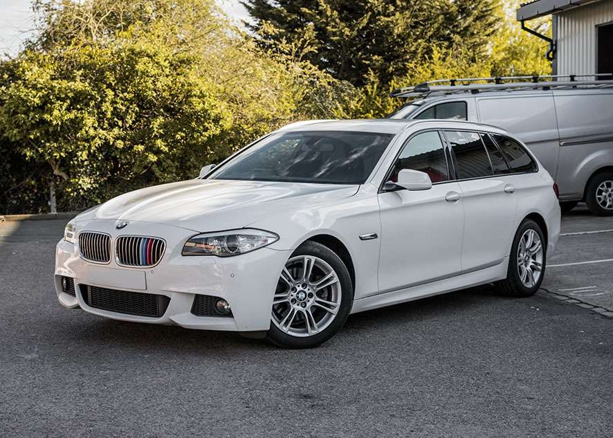 White BMW 5 series with tinted windows