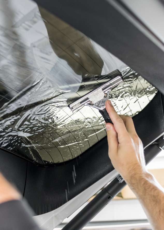 Rear window being tinted using LLumar window tinting film on White BMW X5