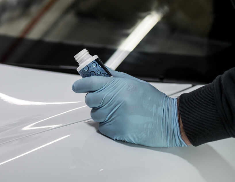 Water repellent being applied to car windowshield