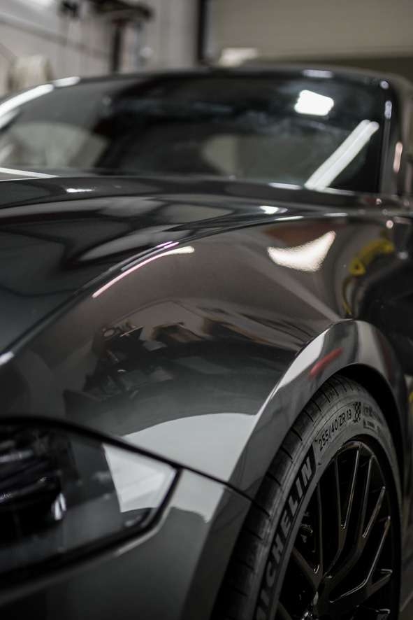 Close up of grey Mustant GT car with shiny paintwork after paint correction