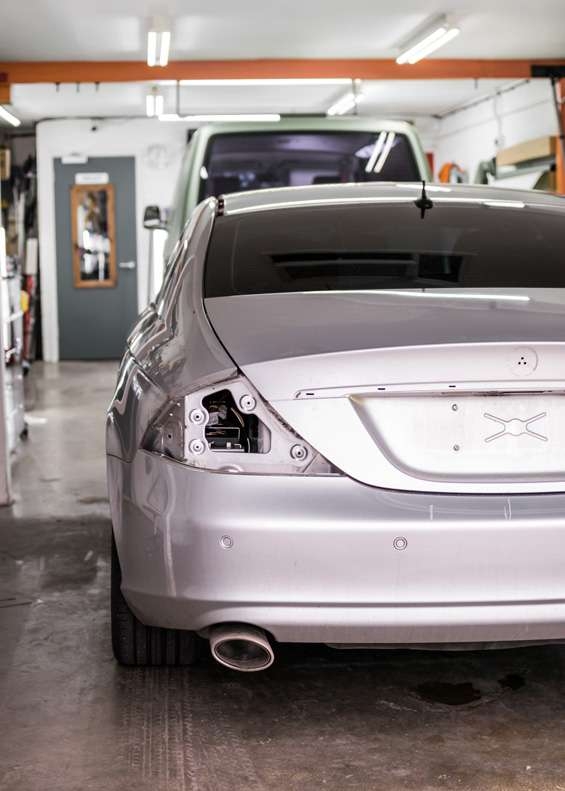 Grey Mercedes CLS car taken apart for vinyl wrapping