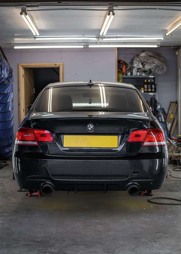 Rear of BMW 335i car with poor/bad/dull paint job before polishing