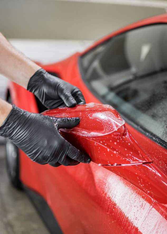 Paint protection film (PPF) being applied to side mirror of Ferrari 458 GTB
