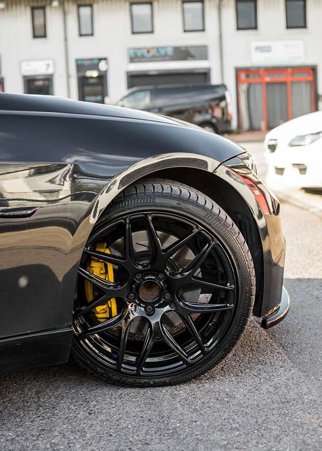 Black BMW 335i wheels after painting, wheel restoration and caliper sprayed yellow