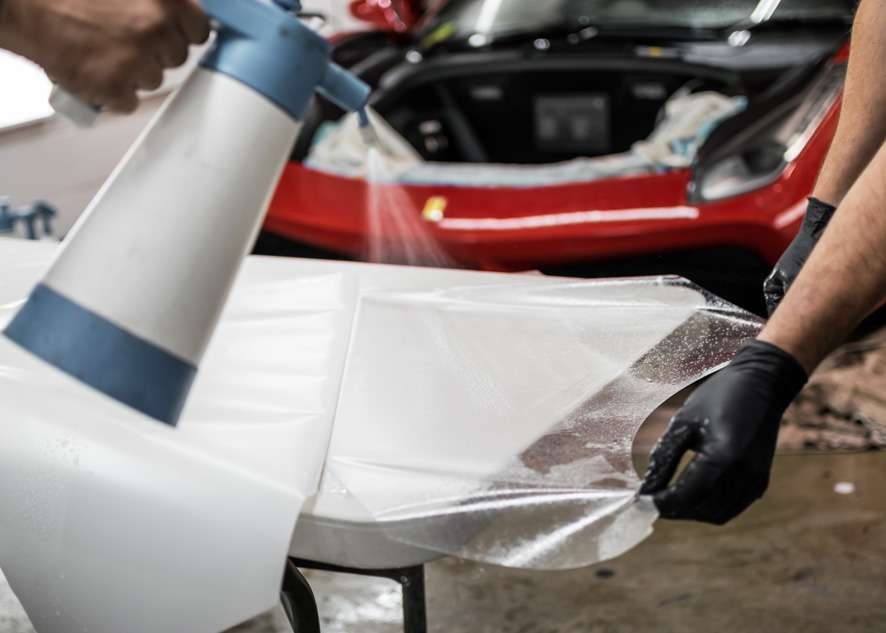 Paint protection film (PPF) being peeled