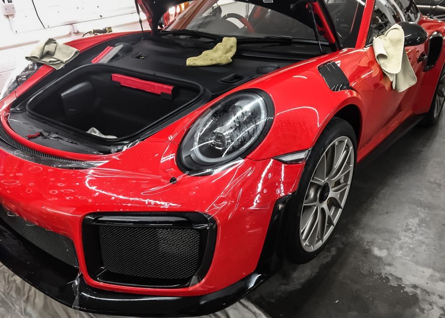 Paint protection film application on Porsche 911 GT2RS red car