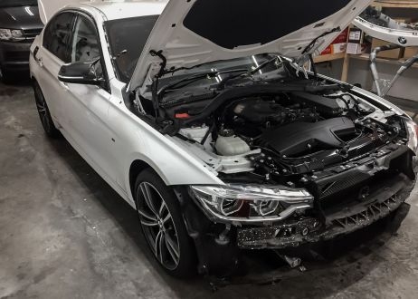 BMW 3 series car being vinyl wrapped in khaki green